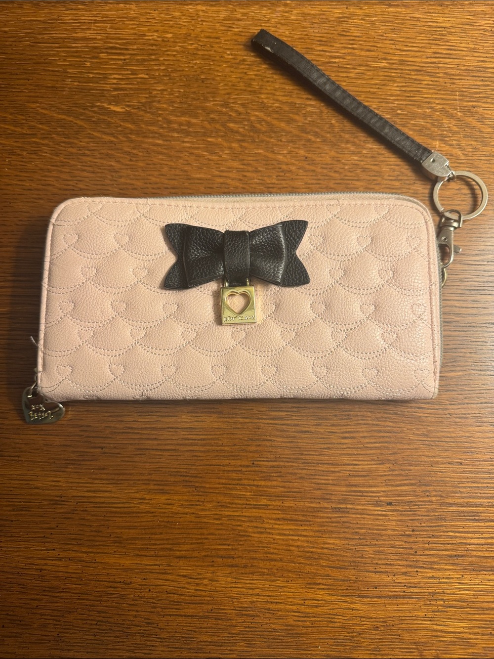 Heart-Embossed Pink Wristlet Wallet with Black Bow
Betsy Johnson